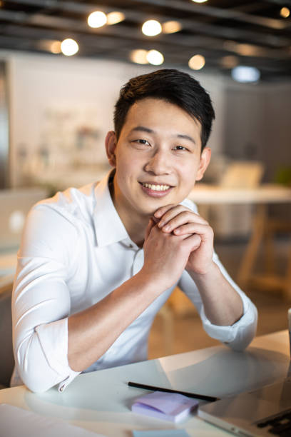 istock Portrait of smiling Asian coworker 1159664251