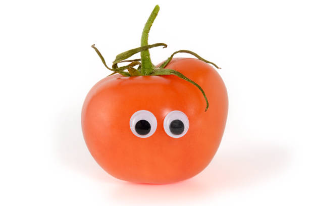 istock Googly eyes. Funny cute light red mister Fresh Tomato, isolated on white background. 1159666811
