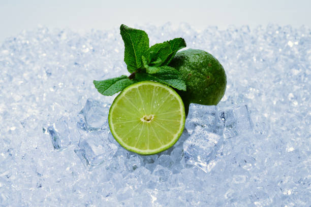 istock Juicy fresh lime and mint on ice cubes. 1159667660