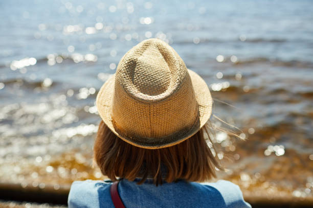 istock Young Woman Looking at Sea 1159669280