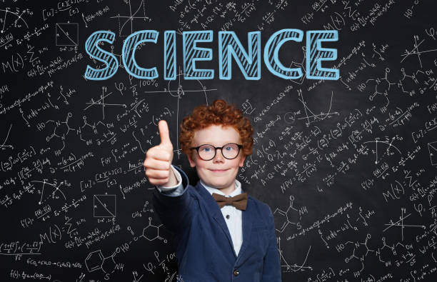 istock Happy child student holding thumb up on blackboard background with science and maths formula. Learn science 1159669339