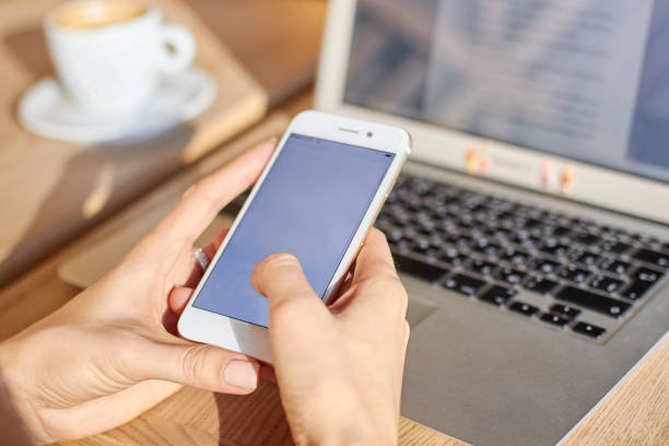 istock Women hold smartphone during coffee break in a cafe 1159672308