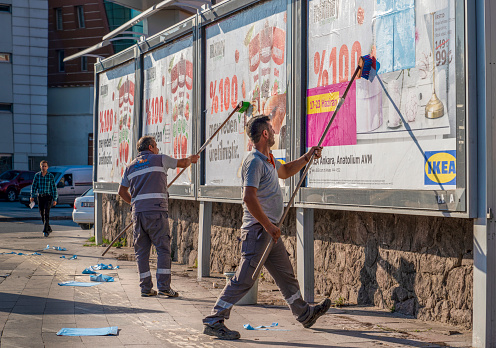 Ankara/Turkey-June 23 2019: Workers remove and install advertising on a billboard.