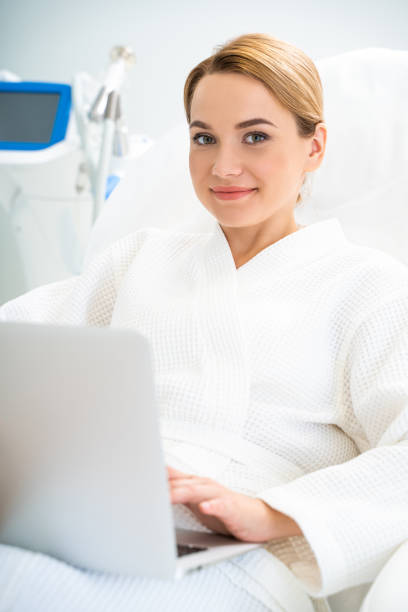 istock Caucasian beautiful woman situating in cosmetology office and using computer 1159676095
