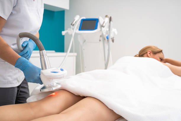 istock Massagist making vacuum roller massage with new apparatus for female client 1159676209