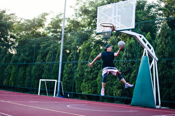istock Streetball player shoots basket 1159677546