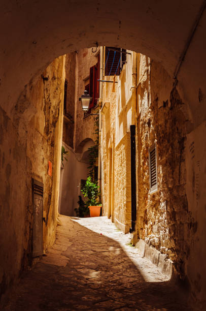 istock Narrow passage between the buildings in Italy 1159678571