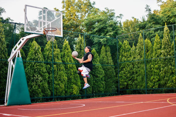 istock Streetball player shoots basket 1159678584