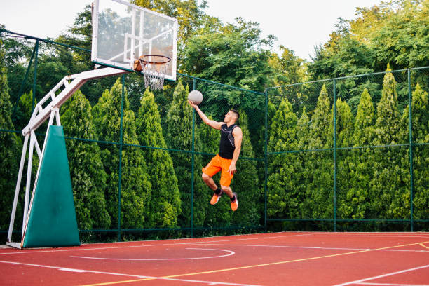 istock Streetball player shoots basket 1159678653
