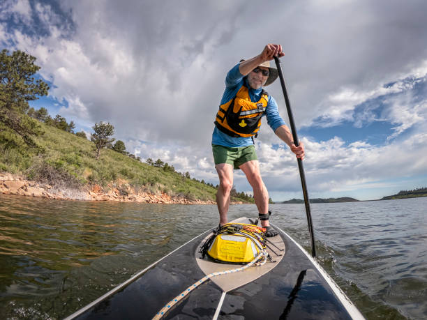 istock stand up paddling on a lake in Colorado 1159679174