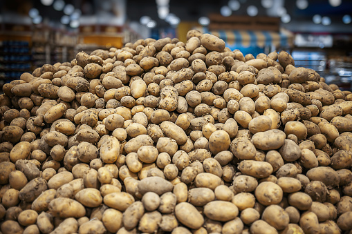 Closeup of fresh organic harvest potatoes on the supermarket shelf