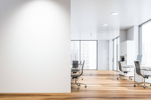 White open space office with mock up wall Interior of open space office of modern company with rows of computer desks and meeting room. Mock up wall on the left. 3d rendering no people stock pictures, royalty-free photos & images