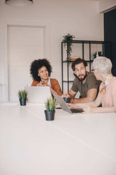 istock Small group of happy business colleagues talking 1159681745