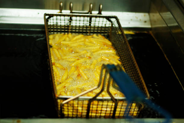 istock potato chips frying  in a deep fat fryer 1159682185