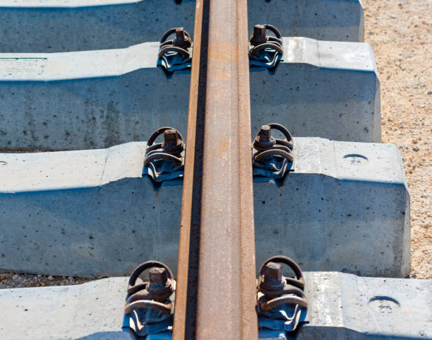 Rails, sleepers and mounting nuts close up Rails, sleepers and mounting nuts close up railroad track concrete railway sleeper thoroughfare stock pictures, royalty-free photos & images