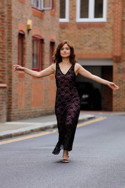 istock A young women stands at the wall 1159683906