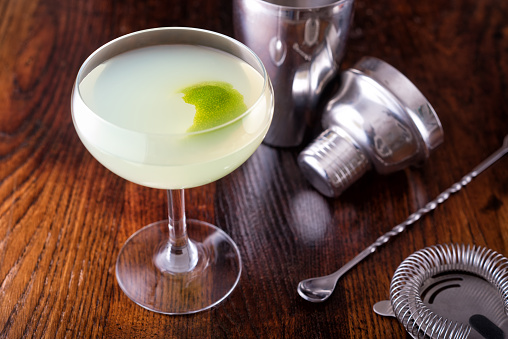 A delcious classic daiquiri on a wooden bar counter top.