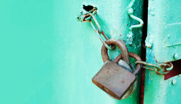 istock Metal door with Two old rusty padlock. Copy space. Security and protection conception 1159688265