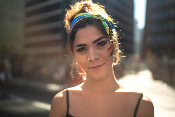 transgender-frau schaut während der pride parade in die kamera - trans stock-fotos und bilder