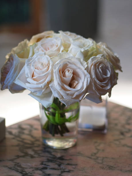 istock Bouquet of white roses on a table 1159690491