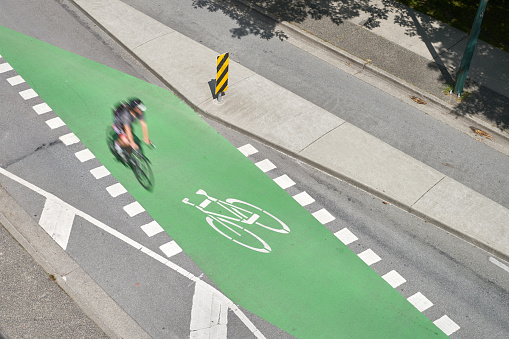 A bicycle only lane and crosswalk crossing in downtown Vancouver.