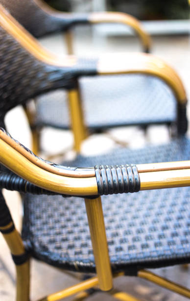 istock Traditional French Cafe Chairs: Rustic Black and White Wicker Close-Up 1159692539