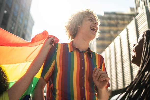 istock Friends dancing and having fun during pride parade 1159693498
