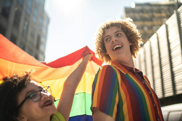 istock Friends dancing and having fun during pride parade 1159695638