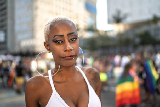 istock Confident lesbian woman looking at camera during pride parade 1159695862