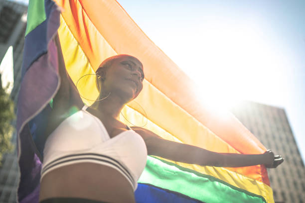 istock Confident lesbian woman holding rainbow flag 1159695864