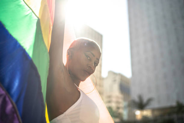 istock Confident lesbian woman holding rainbow flag 1159695870