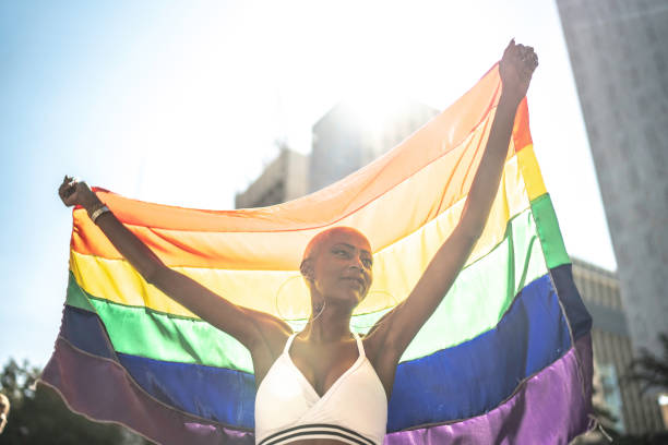 istock Confident lesbian woman holding rainbow flag 1159695872