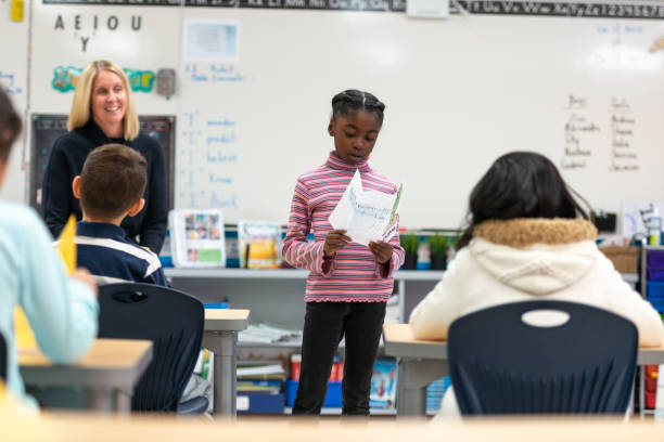 istock Young African Girl Presenting to Her Class 1159700177