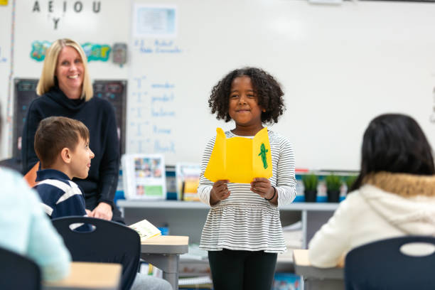 istock Young African Girl Presenting to Her Class 1159700178