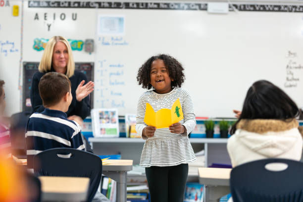 istock Young African Girl Presenting to Her Class 1159700179