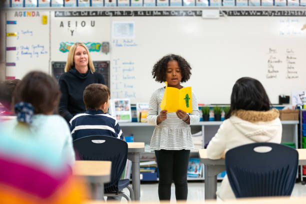 istock Young African Girl Presenting to Her Class 1159700181