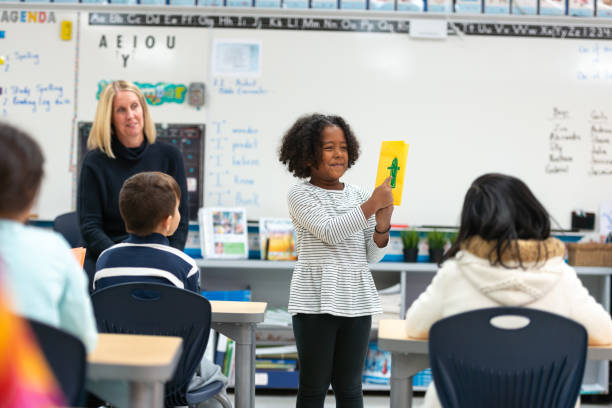 istock Young African Girl Presenting to Her Class 1159700182