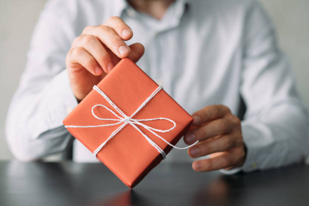 istock office delivery service business man red gift box 1159700434