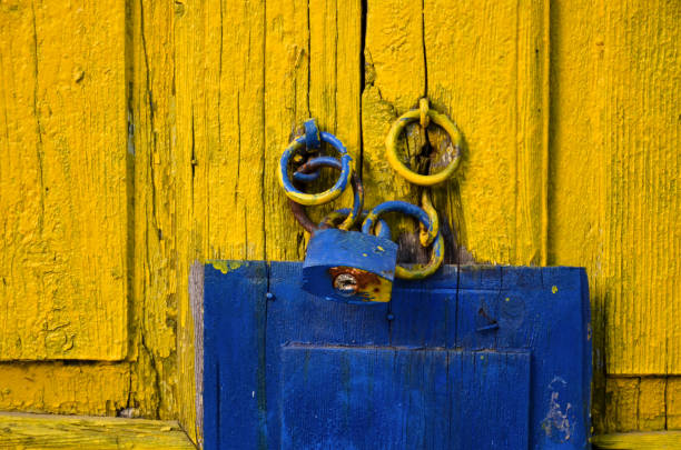 istock old yellow door and lock 1159701185