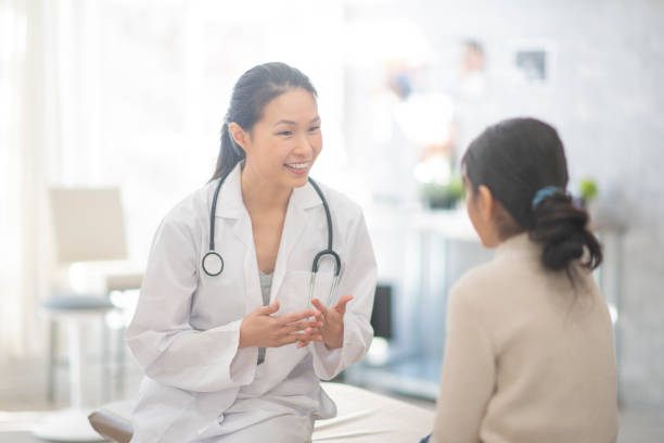 istock Doctor Comforting A Girl 1159701505