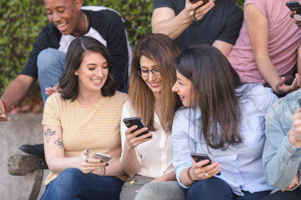 istock Diverse group of college students using smart phones 1159701532