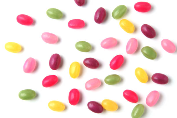 colorful candies jelly beans spread on white background