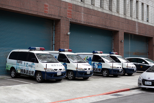 Taipei, Taiwan - May 5, 2019: Taiwanese Police vehicles lined out outside the read of a Police station in Taipei