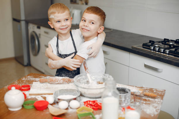 istock Little boy cook the dough for cookies 1159707308