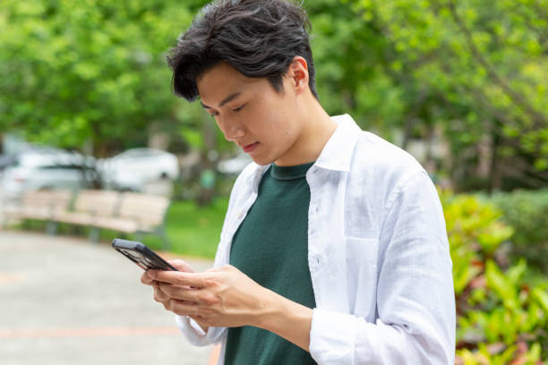 istock Young Man Using Phone App To Get a Ride Sharing Car or Taxi 1159707320