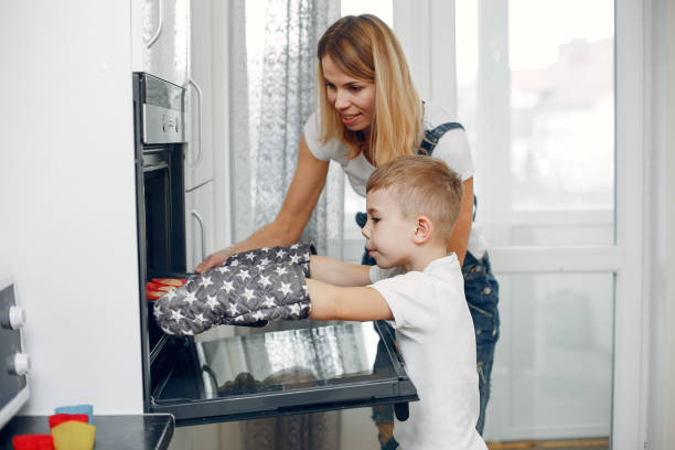 Cute mother with little son in a room stock photo