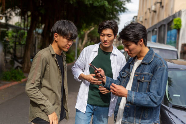 istock Young Men Using Phone Apps To Get a Ride Sharing Car or Taxi 1159707642