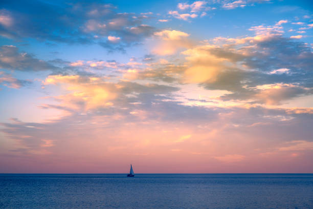 Beautiful sunset over Lake Superior with a sail boat on horizon, taken at Canal Park, Duluth, Minnesota