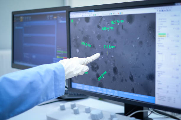 Scientist is analyze nanomaterials with Scanning Electron Microscope (SEM) machine in laboratory (ฺDisplay show Silver nanoparticle produced from natural compound) stock photo