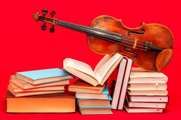 Stack of Books and old violin - conceptual photography stock photo